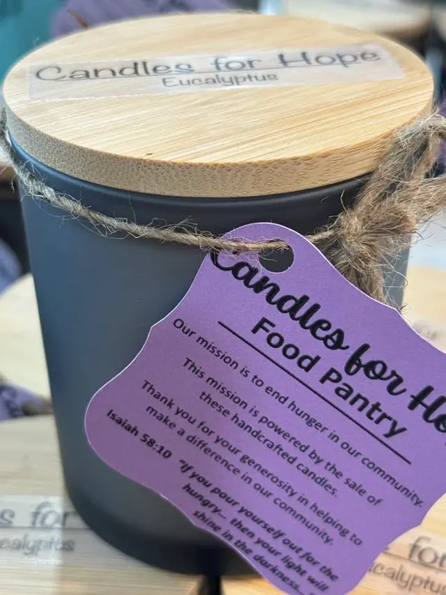 Eucalyptus candle in a matte black jar with a bamboo lid, tied with twine and a Candles for Hope tag